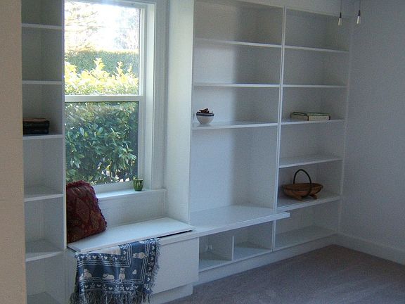 bedroom with built-in shelving and window seat