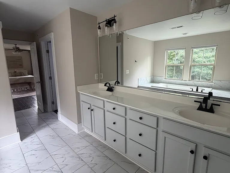 Spacious double vanity featuring ample drawer storage and modern finishes.