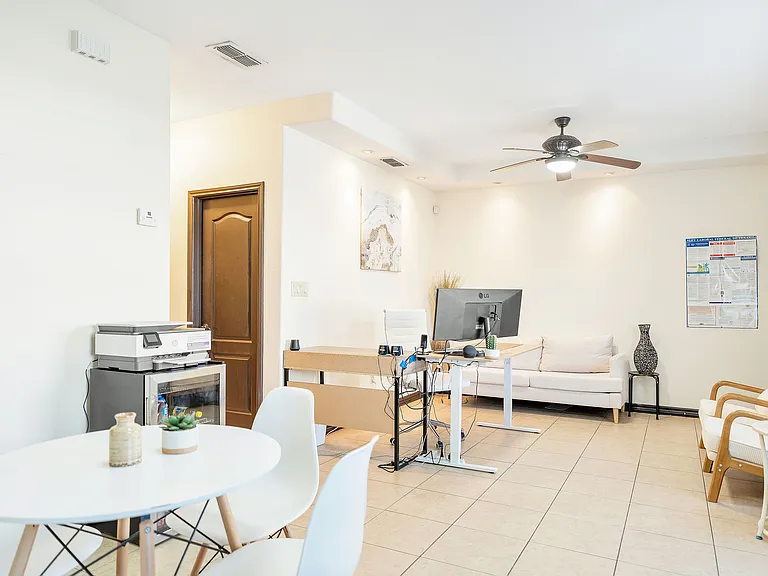 Interior of a living room in Merida Vista Apartments, featuring a white table and chairs, designed for comfort and style