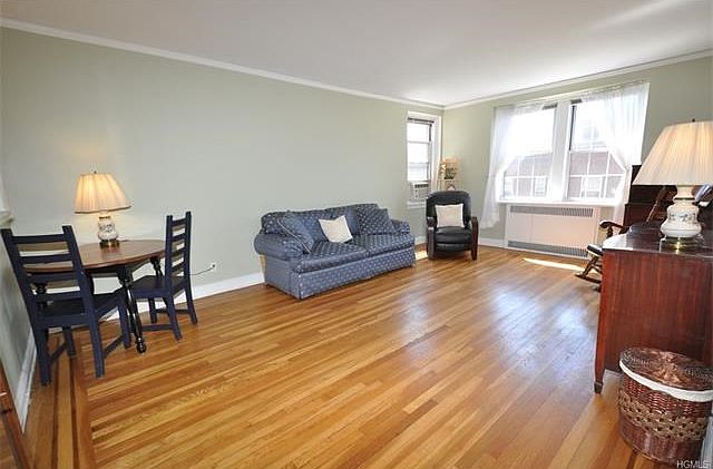 The large bright and airy living area has sunny Southern exposures, built-in bookcase and refinished hardwood floors.  The room is 20'-4" x 13'-0".