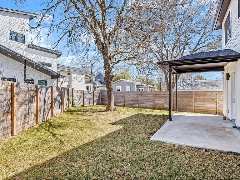 back porch & fully enclosed back yard, sprinkler system. Photo taken in winter