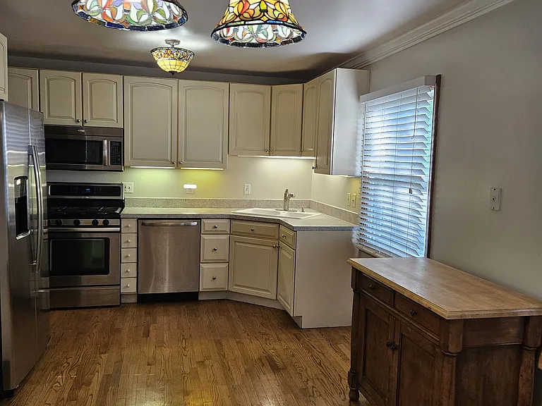 Breakfast area and Kitchen w/ Movable Kitchen Island, under cabinet lights, two windows w/ 2" white blinds