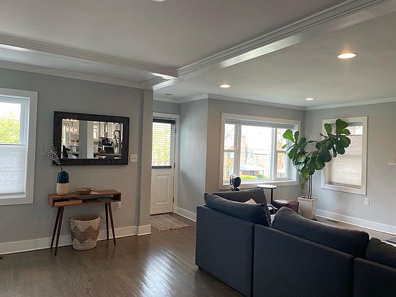 Entryway and view of large windows. All blinds go top down and bottom up for optimal privacy and light. Hilltop location allows the front windows to look out at trees instead of street.