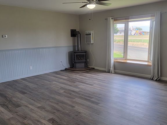 Living room, has bay windows and a propane stove