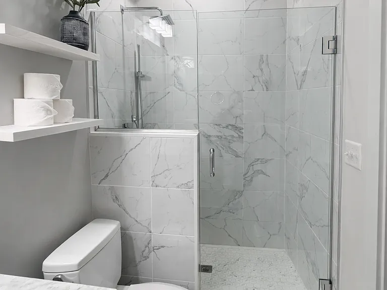 The primary bathroom includes a waterfall shower