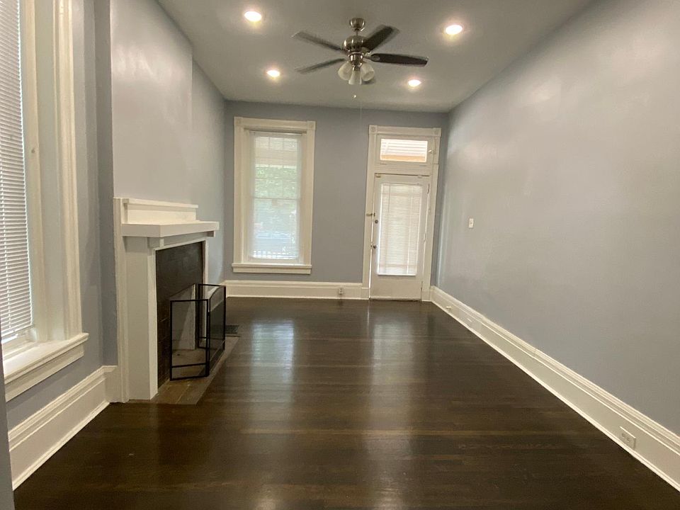 Spacious living room area. Stained hardwood floors, led lighting and fireplace(non functional)