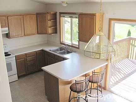 Kitchen and breakfast bar
						:
						Oak cabinets with plenty of storage. Glass sliders to walk-out 10x12 deck.