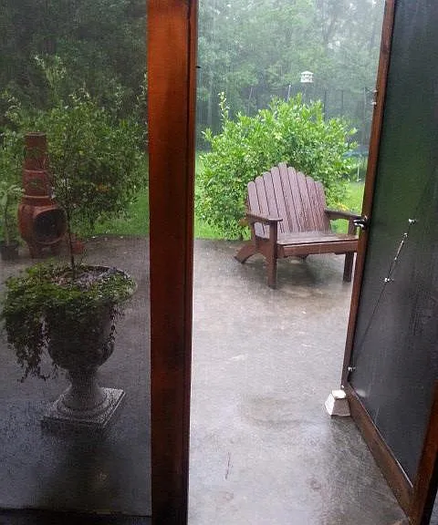 Screened Room leads out to large sitting area and lush back yard
