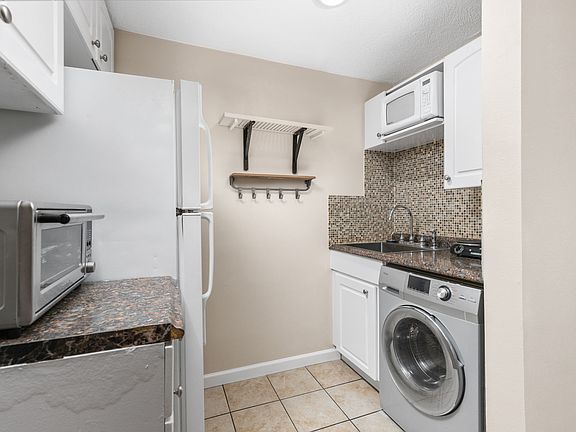 Kitchenette with washer/dryer, refrigerator & freezer, microwave, toaster oven.