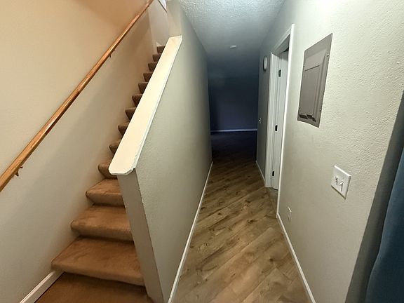 Hallway to downstairs living area and staircase to second floor.