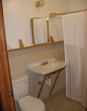 shower in tiled bathroom is not in view, no tub
