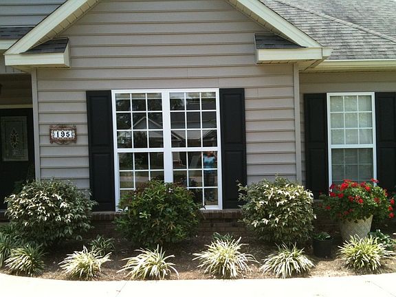 Front flower bed.
						:
						In front of dining room window.