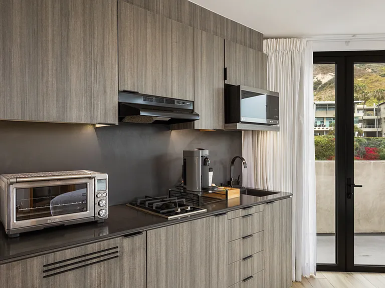 Enjoy a well-equipped kitchenette boasting top-of-the-line appliances and a convenient coffee machine stocked with pods for your enjoyment.