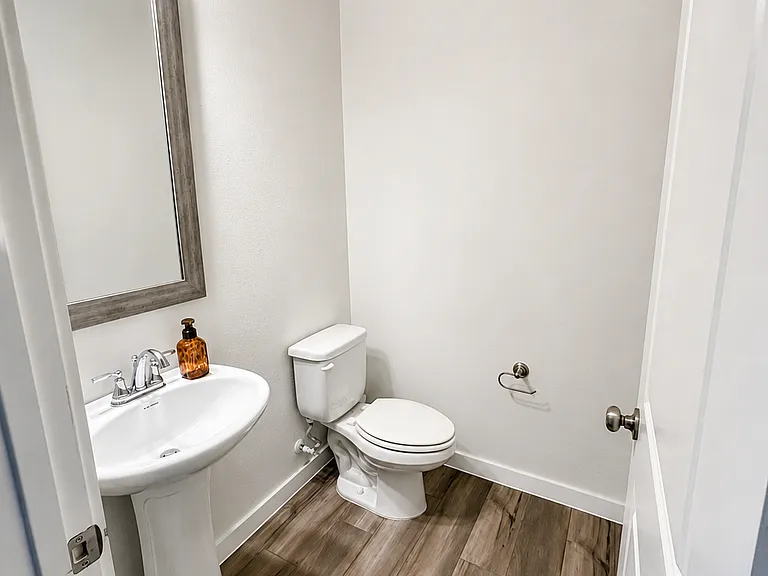 Half bath in main floor, view from hallway by kitchen