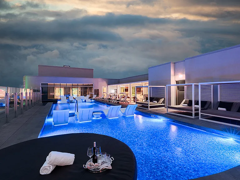 One UptowStunning rooftop pool with city views and lounge seating
