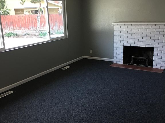 LIVING RM W/ BRICK FIREPLACE