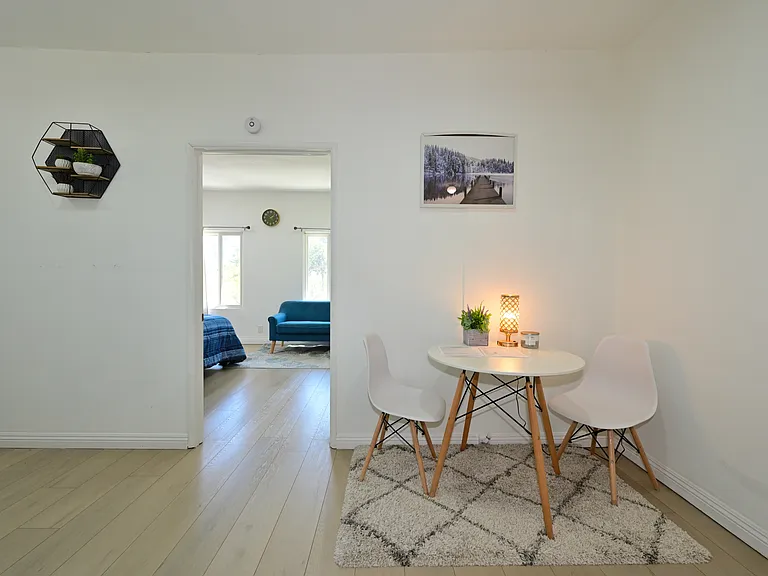 Fully furnished living room with upgraded kitchen, appliances, and laundry machines
