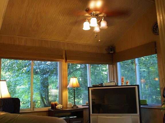 Large sunroom shows off the beautiful wooded back yard!