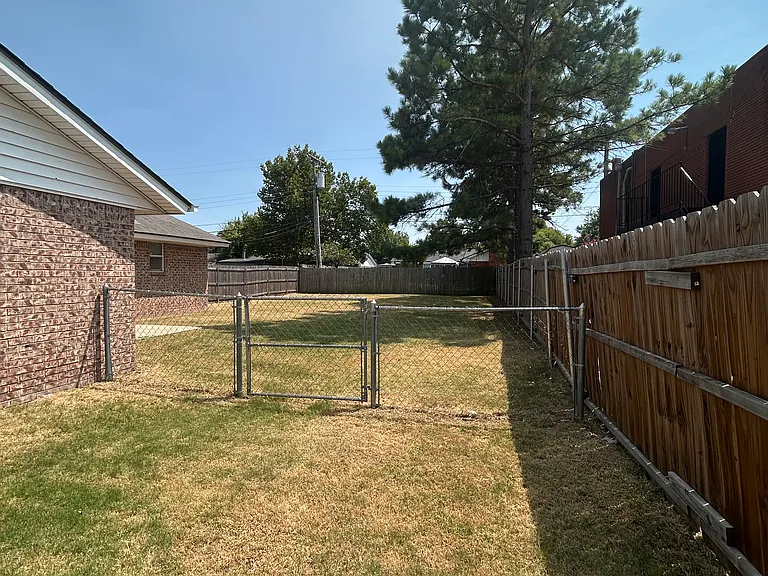 Gate to large fenced back yard