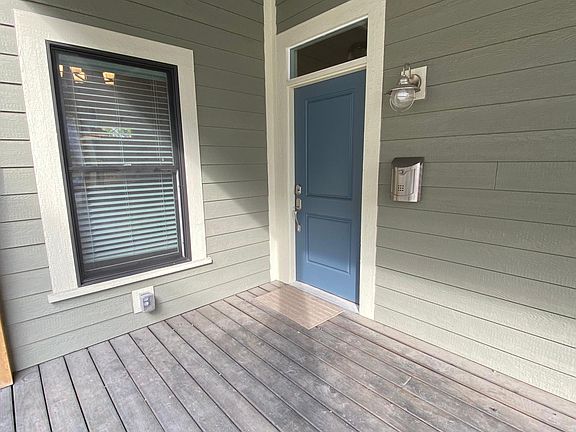 Safe and secure front porch with ceiling fan, electrical outlets, and keyless entry.
