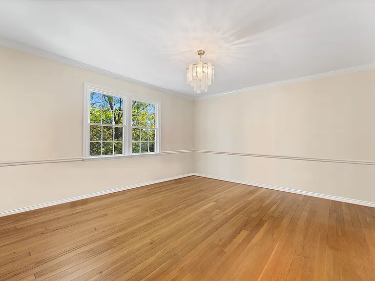 Dining room sports hardwood flooring & large windows