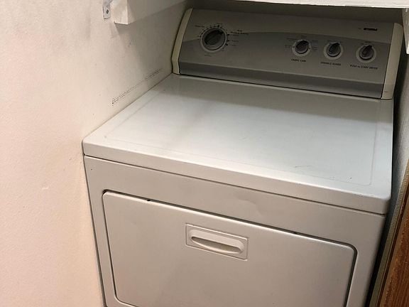 Dryer and water heater in closet off kitchen.