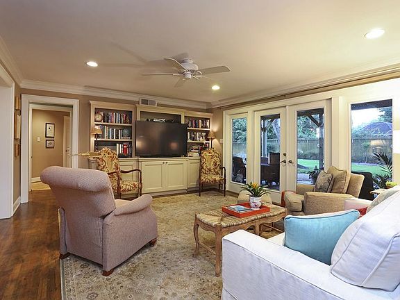 Another view of the Living Room (19x13) showing the built in cabinets, crown molding, windows and do