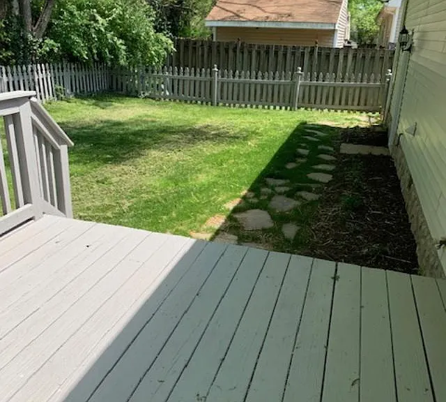 Stone walkway up to deck in back yard,