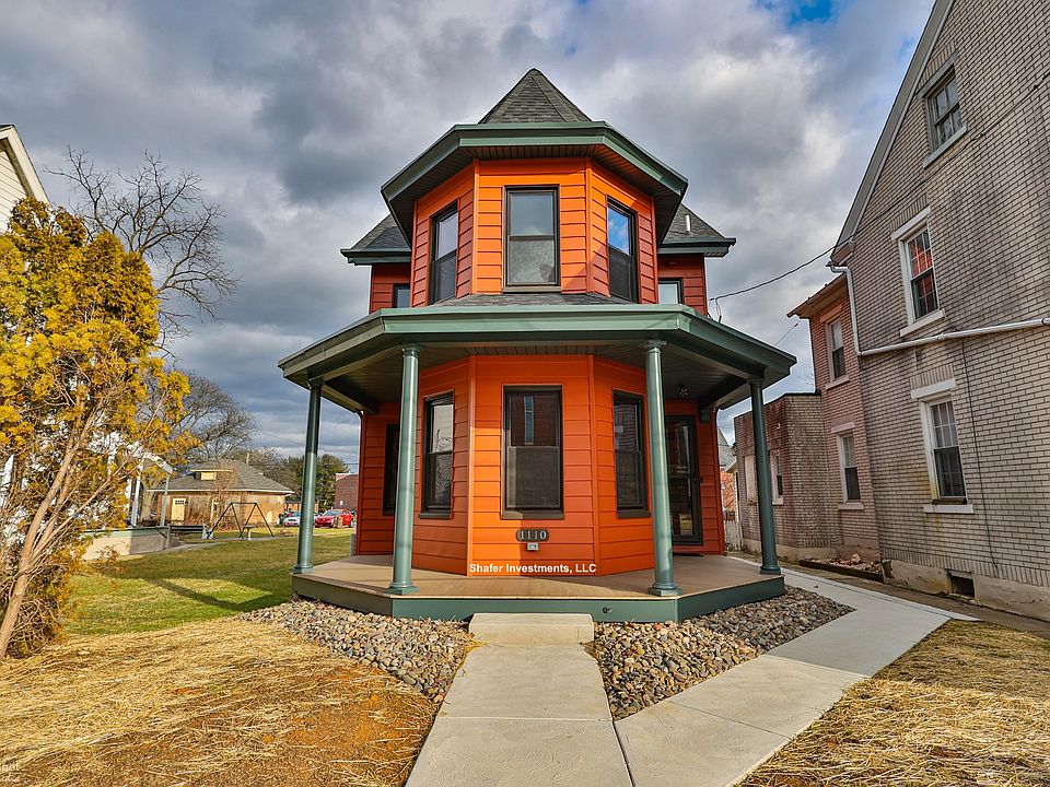 The photo showcases the beautiful exterior of the front of the house and its wrap-around porch.