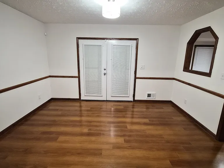 Dining Room with deck double doors and bay window into Kitchen
