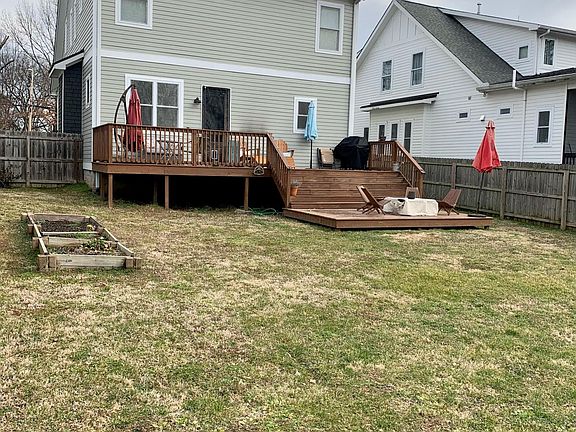 Large deck and fenced in backyard.
