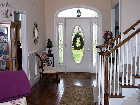 2 story entry foyer with hardwood floors and triple crown 