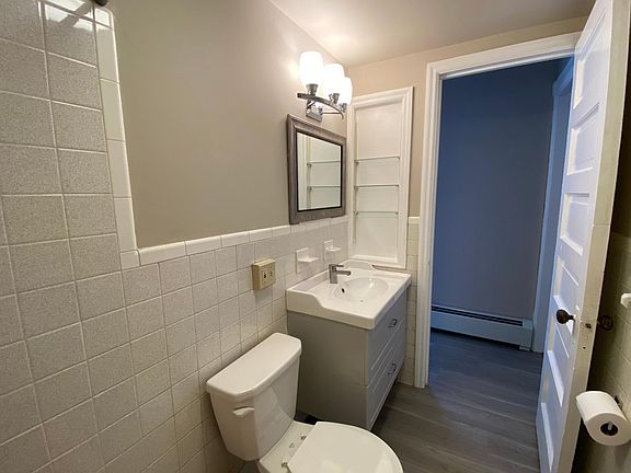 RENOVATED BATH WITH NEW VANITY AND CHARM OF MID-CENTURY TILE