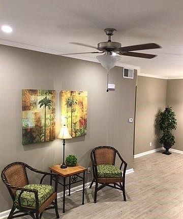 Living room-- fresh paint and porcelain tile throughout!  Wide crown moulding, cans overhead lighting for the wow factor!