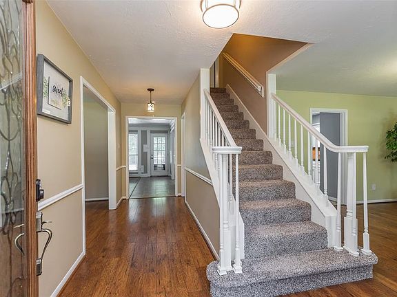 Inviting entry with hi-end wood-look laminate flooring, mahogany leaded glass front door and additional storm door for added protection. Formal dining RM sits to the right with living RM to the left.
