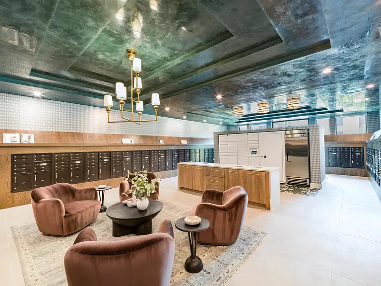The package lounge at Modera Trailhead combines convenience and comfort, with lockers and stylish seating for a refined touch.