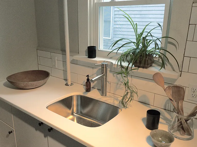 Stainless kitchen sink, tiled backsplash