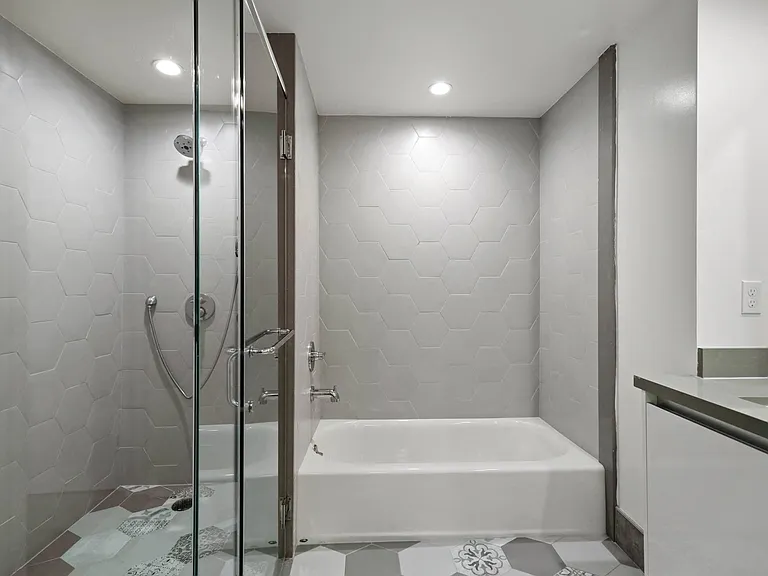 Bathroom with Bathtub and Walk-In Shower with Glass Door