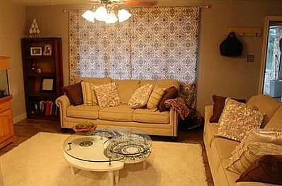 Family Room. Living room. Spacious! Pictured with two full size couches, large coffee table, bookshelf, and large fish tank.