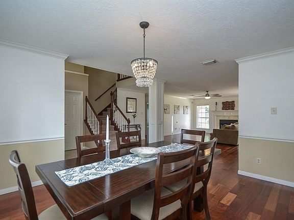 The crown molding and chair rai ladds a hint of elegance to the dining room. The shades of wall paint produces warmth throughout the home.