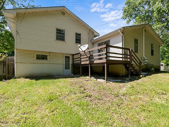 rear of home with deck and fenced backyard!