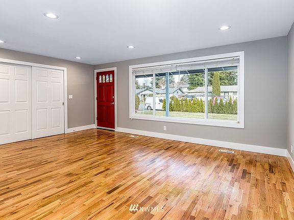 Living area with natural light through a massive window.