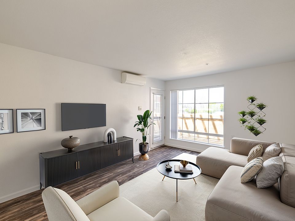 Airy living room with warm, modern finishes.