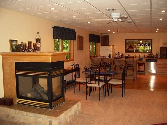 Lower level Great Room w/three sided fireplace, wet bar, 3/4 bath