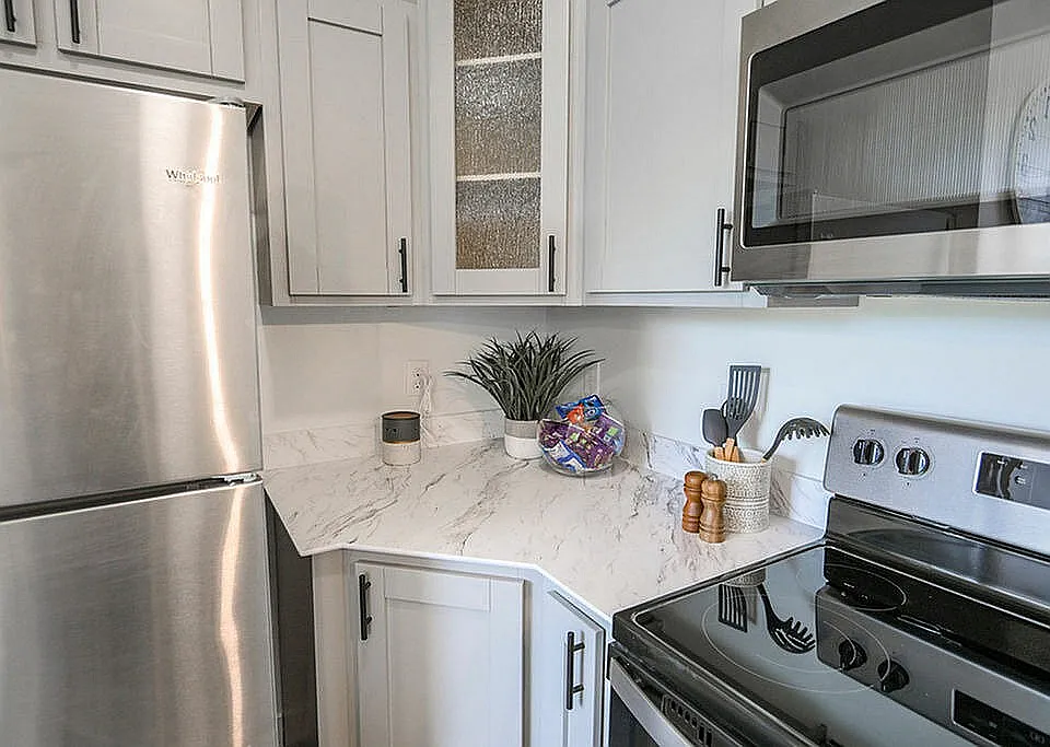 Modern kitchen with sleek stainless steel appliances, elegant marble countertops, and stylish cabinetry creating a sophisticated culinary space.