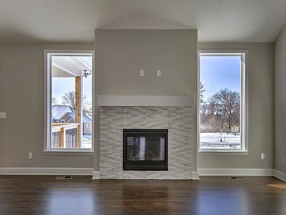 Natural light surrounds the focal point fireplace