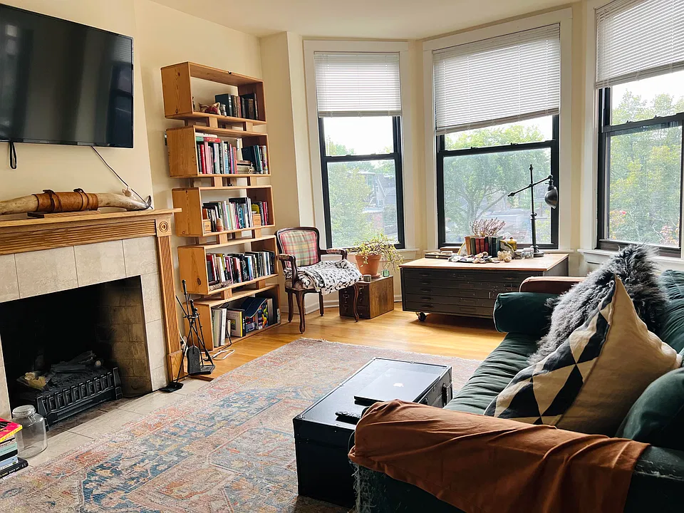 Living room, decorative fireplace, bayed windows facing south