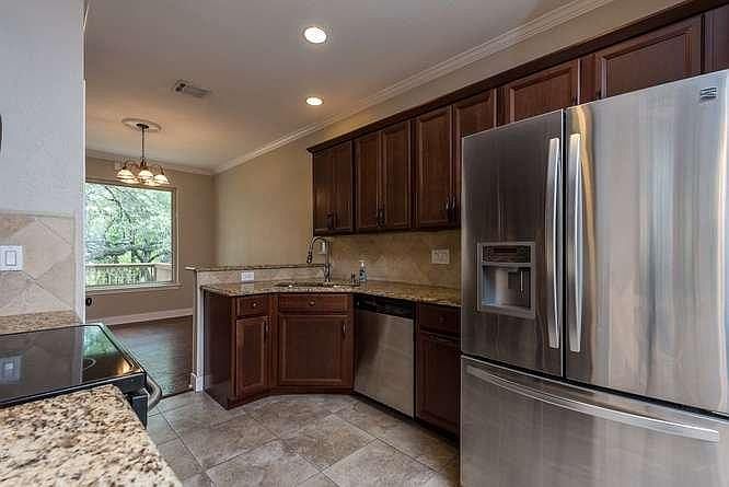 Kitchen with stainless steel appliances included. Washer and dryer nook located here also.