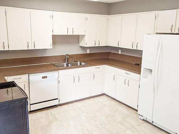 Large open kitchen and dining area includes major appliances.