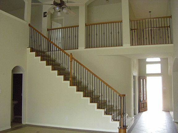 View to upstairs gameroom with iron spindle railings